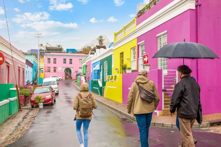 Guests walking up a Bo-Kaap street of brightly painted houses